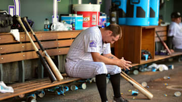 DENVER, CO - JUNE 02: Bryan Shaw #29 of the Colorado Rockies hangs his head in the dugout after being pulled after pitching 1/3 inning and allowing 3 runs in the seventh inning of a game against the Los Angeles Dodgers at Coors Field on June 2, 2018 in Denver, Colorado. (Photo by Dustin Bradford/Getty Images)