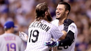 DENVER, CO - AUGUST 01: Nolan Arenado #28 of the Colorado Rockies celebrates with Charlie Blackmon #19 after driving in the game winning run in the ninth inning against the New York Mets at Coors Field on August 1, 2017 in Denver, Colorado. (Photo by Matthew Stockman/Getty Images)