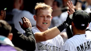 DENVER, CO - JULY 23: Pat Valaika #4 of the Colorado Rockies is congratulated in the dugout after hitting a home run in the sixth inning against the Pittsburgh Pirates at Coors Field on July 23, 2017 in Denver, Colorado. (Photo by Matthew Stockman/Getty Images)