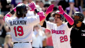 DENVER, CO - MAY 14: Charlie Blackmon #19 of the Colorado Rockies congratulates Nolan Arenado #28 after his 2 RBI home run in the fifth inning against the Los Angeles Dodgers at Coors Field on May 14, 2017 in Denver, Colorado. Members of both teams were wearing pink in commemoration of Mother's Day weekend. (Photo by Matthew Stockman/Getty Images)