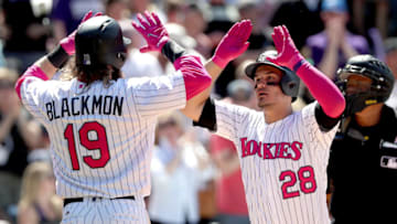 DENVER, CO - MAY 14: Charlie Blackmon #19 of the Colorado Rockies congratulates Nolan Arenado #28 after his 2 RBI home run in the fifth inning against the Los Angeles Dodgers at Coors Field on May 14, 2017 in Denver, Colorado. Members of both teams were wearing pink in commemoration of Mother's Day weekend. (Photo by Matthew Stockman/Getty Images)