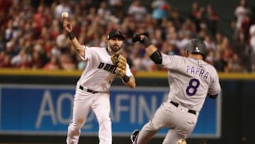 PHOENIX, AZ - OCTOBER 04: Infeilder Daniel Descalso #3 of the Arizona Diamondbacks throws over the sliding Gerardo Parra #8 of the Colorado Rockies during the National League Wild Card game at Chase Field on October 4, 2017 in Phoenix, Arizona. (Photo by Christian Petersen/Getty Images)