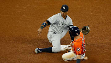 HOUSTON, TX - OCTOBER 13: Jose Altuve #27 of the Houston Astros steals second against Starlin Castro #14 of the New York Yankees in the fourth inning during game one of the American League Championship Series at Minute Maid Park on October 13, 2017 in Houston, Texas. (Photo by Bob Levey/Getty Images)