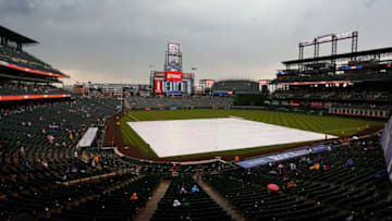 DENVER, CO - SEPTEMBER 17: The tarp sits on the field during a rain delay in the fifth inning of a regular season MLB game between the Colorado Rockies and the visiting San Diego Padres at Coors Field on September 17, 2017 in Denver, Colorado. (Photo by Russell Lansford/Getty Images)