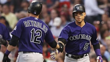 BOSTON, MA - MAY 26: Mark Reynolds #12 of the Colorado Rockies congratulates Carlos Gonzalez #5 after he hit a two run homer against the Boston Red Sox during the fourth inning at Fenway Park on May 26, 2016 in Boston, Massachusetts. (Photo by Maddie Meyer/Getty Images)