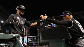 PHOENIX, AZ - MARCH 30: Ian Desmond #20 of the Colorado Rockies high fives manager Bud Black #10 after hitting a two-run home run against the Arizona Diamondbacks during the second inning of the MLB game at Chase Field on March 30, 2018 in Phoenix, Arizona. (Photo by Christian Petersen/Getty Images)
