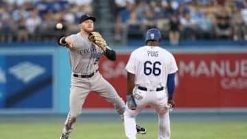 LOS ANGELES, CA - SEPTEMBER 09: Shortstop Trevor Story #27 of the Colorado Rockies throws to first to complete a double play to end the second inning after forcing out Yasiel Puig #66 of the Los Angeles Dodgers at Dodger Stadium on September 9, 2017 in Los Angeles, California. (Photo by Stephen Dunn/Getty Images)