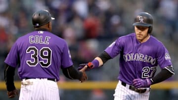 DENVER, CO - MAY 12: Trevor Story #27 of the Colorado Rockies is congratulated by thrid base coach Stu Cole #39 as he circles the bases after hitting a 2 RBI home run in the first inning against the Milwaukee Brewers at Coors Field on May 12, 2018 in Denver, Colorado. (Photo by Matthew Stockman/Getty Images)