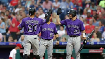 PHILADELPHIA, PA - JUNE 13: Ian Desmond #20 of the Colorado Rockies high-fives Tom Murphy #23 after hitting a two-run home run in the fourth inning during a game against the Philadelphia Phillies at Citizens Bank Park on June 13, 2018 in Philadelphia, Pennsylvania. (Photo by Hunter Martin/Getty Images)