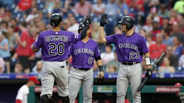 PHILADELPHIA, PA - JUNE 13: Ian Desmond #20 of the Colorado Rockies high-fives Tom Murphy #23 after hitting a two-run home run in the fourth inning during a game against the Philadelphia Phillies at Citizens Bank Park on June 13, 2018 in Philadelphia, Pennsylvania. (Photo by Hunter Martin/Getty Images)