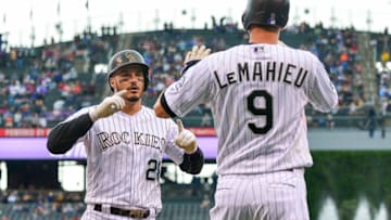 DENVER, CO - JUNE 24: Nolan Arenado #28 of the Colorado Rockies celebrates as he crosses the plate toward DJ LeMahieu #9 after both scored on an Arenado homerun off of Caleb Smith #31 of the Miami Marlins in the first inning of a game against the Miami Marlins at Coors Field on June 24, 2018 in Denver, Colorado. (Photo by Dustin Bradford/Getty Images)
