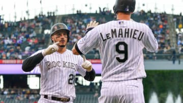 DENVER, CO - JUNE 24: Nolan Arenado #28 of the Colorado Rockies celebrates as he crosses the plate toward DJ LeMahieu #9 after both scored on an Arenado homerun off of Caleb Smith #31 of the Miami Marlins in the first inning of a game against the Miami Marlins at Coors Field on June 24, 2018 in Denver, Colorado. (Photo by Dustin Bradford/Getty Images)