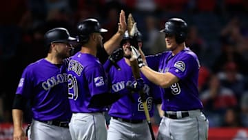 ANAHEIM, CA - AUGUST 27: Ian Desmond #20, David Dahl #26, and Chris Iannetta #22 congratulate DJ LeMahieu #9 of the Colorado Rockies after his grand slam homerun during the eighth inning of a game against the Los Angeles Angels of Anaheim at Angel Stadium on August 27, 2018 in Anaheim, California. (Photo by Sean M. Haffey/Getty Images)