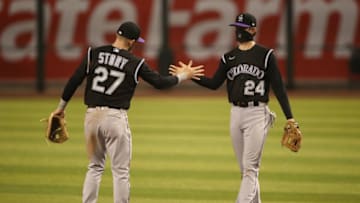 PHOENIX, ARIZONA - AUGUST 24: Infielders Ryan McMahon #24 and Trevor Story #27 of the Colorado Rockies celebrate after defeating the Arizona Diamondbacks during the ninth inning of the MLB game at Chase Field on August 24, 2020 in Phoenix, Arizona. The Rockies defeated the Diamondbacks 3-2. (Photo by Christian Petersen/Getty Images)