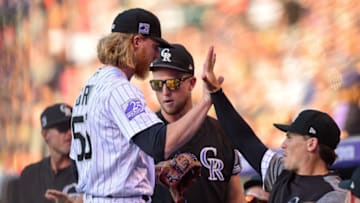 DENVER, CO - JULY 14: Jon Gray #55 of the Colorado Rockies is congratulated by Tony Wolters #14 and Kyle Freeland #21 after pitching a perfect first inning against the Seattle Mariners during a game at Coors Field on July 14, 2018 in Denver, Colorado. (Photo by Dustin Bradford/Getty Images)