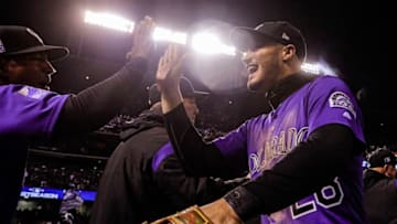 DENVER, CO - SEPTEMBER 28: Nolan Arenado #28 of the Colorado Rockies high fives teammates after the Rockies earned a postseason berth by beating the Washington Nationals 5-2 at Coors Field on September 28, 2018 in Denver, Colorado. (Photo by Joe Mahoney/Getty Images)