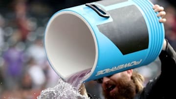 DENVER, COLORADO - MAY 27: Charlie Blackmon #19 of the Colorado Rockies douses Raimel Tapia #15 with water after Tapia drove in the winning run with a walk off single in the 11th inning against the Arizona Diamondbacks at Coors Field on May 27, 2019 in Denver, Colorado. (Photo by Matthew Stockman/Getty Images)