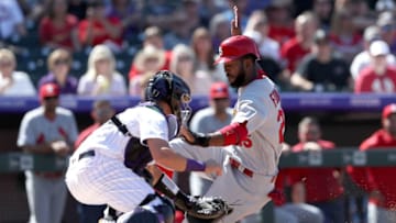 DENVER, COLORADO - SEPTEMBER 12: Dexter Fowler #25 of the St Louis Cardinals is tagged out at the plate by Dom Nunez #58 of the Colorado Rockies in the fourth inning at Coors Field on September 12, 2019 in Denver, Colorado. (Photo by Matthew Stockman/Getty Images)
