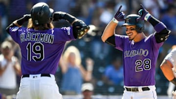 DENVER, CO - AUGUST 18: Nolan Arenado #28 of the Colorado Rockies celebrates with Charlie Blackmon #19 after hitting an eighth inning two-run home run against the Miami Marlins at Coors Field on August 18, 2019 in Denver, Colorado. (Photo by Dustin Bradford/Getty Images)