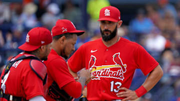 Mar 11, 2020; Port St. Lucie, Florida, USA; St. Louis Cardinals third baseman Matt Carpenter (right) walked to the pitchers mound to talk with starting pitcher Carlos Martinez (center) as catcher Yadier Molina (left) listen in during a spring training game against the New York Mets at Clover Park. Mandatory Credit: Steve Mitchell-USA TODAY Sports