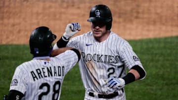 Jul 31, 2020; Denver, Colorado, USA; Colorado Rockies shortstop Trevor Story (27) celebrates his solo home run with third baseman Nolan Arenado (28) in the seventh inning against the San Diego Padres at Coors Field. Mandatory Credit: Isaiah J. Downing-USA TODAY Sports