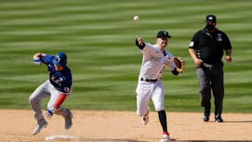 Aug 16, 2020; Denver, Colorado, USA; Colorado Rockies shortstop Trevor Story (27) turns a double play as Texas Rangers center fielder Scott Heineman (16) slides into second in the eighth inning at Coors Field. Mandatory Credit: Isaiah J. Downing-USA TODAY Sports
