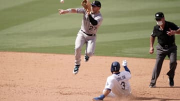 Aug 23, 2020; Los Angeles, California, USA; Los Angeles Dodgers left fielder Chris Taylor (3) slides into second base to beat a throw to Colorado Rockies shortstop Trevor Story (27) for a stolen base in the seventh inning at Dodger Stadium. Mandatory Credit: Kirby Lee-USA TODAY Sports