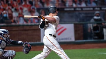 Sep 22, 2020; San Francisco, California, USA; San Francisco Giants left fielder Alex Dickerson (12) hits a solo home run during the seventh inning against the Colorado Rockies at Oracle Park. Mandatory Credit: Neville E. Guard-USA TODAY Sports