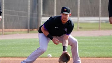 Feb 26, 2021; Scottsdale, Arizona, USA; Colorado Rockies second baseman Ryan McMahon (24) fields the ball during spring training at Salt river Fields. Mandatory Credit: Rick Scuteri-USA TODAY Sports