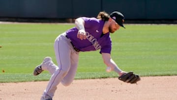 Mar 1, 2021; Glendale, Arizona, USA; Colorado Rockies shortstop Brendan Rodgers (7) commits an error in the fourth inning against the Los Angeles Dodgers during a spring training game at Camelback Ranch. Mandatory Credit: Rick Scuteri-USA TODAY Sports