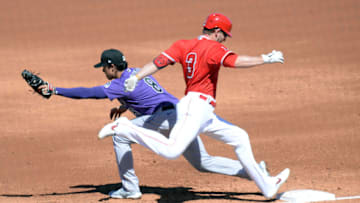Mar 6, 2021; Tempe, Arizona, USA; Los Angeles Angels third baseman Taylor Ward (3) is forced out at first base by Colorado Rockies first baseman Josh Fuentes (8) during the second inning of a spring training game at Tempe Diablo Stadium. Mandatory Credit: Joe Camporeale-USA TODAY Sports