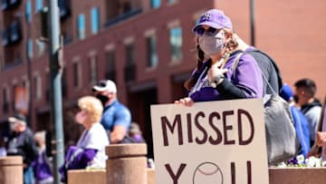 Apr 1, 2021; Denver, Colorado, USA; A fan holds a sign outside of Coors Field before the Opening Day game between the Colorado Rockies and the Los Angeles Dodgers. Mandatory Credit: Isaiah J. Downing-USA TODAY Sports
