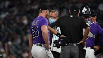 Apr 3, 2021; Denver, Colorado, USA; Colorado Rockies starting pitcher Jon Gray (55) talks to a trainer in the sixth inning against the Los Angeles Dodgers at Coors Field. Mandatory Credit: Ron Chenoy-USA TODAY Sports