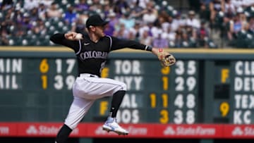 Apr 4, 2021; Denver, Colorado, USA; Colorado Rockies shortstop Trevor Story (27) fields the ball in the sixth inning against the against the Los Angeles Dodgers at Coors Field. Mandatory Credit: Ron Chenoy-USA TODAY Sports