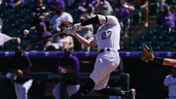 Apr 8, 2021; Denver, Colorado, USA; Colorado Rockies shortstop Trevor Story (27) RBI doubles in the first inning against the Arizona Diamondbacks at Coors Field. Mandatory Credit: Ron Chenoy-USA TODAY Sports