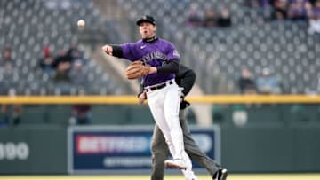 Apr 17, 2021; Denver, Colorado, USA; Colorado Rockies second baseman Ryan McMahon (24) throws to first for an out in the first inning against the New York Mets at Coors Field. Mandatory Credit: Isaiah J. Downing-USA TODAY Sports