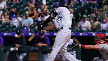 Apr 25, 2021; Denver, Colorado, USA; Colorado Rockies first baseman C.J. Cron (25) singles in the sixth inning at against the Philadelphia Phillies at Coors Field. Mandatory Credit: Ron Chenoy-USA TODAY Sports