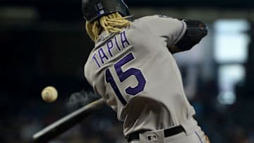 May 2, 2021; Phoenix, Arizona, USA; Colorado Rockies left fielder Raimel Tapia (15) hits an RBI single against the Arizona Diamondbacks during the eighth inning at Chase Field. Mandatory Credit: Joe Camporeale-USA TODAY Sports