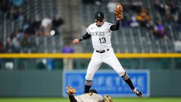 May 11, 2021; Denver, Colorado, USA; San Diego Padres left fielder Tommy Pham (28) steals second under Colorado Rockies shortstop Alan Trejo (13) in the sixth inning at Coors Field. Mandatory Credit: Ron Chenoy-USA TODAY Sports