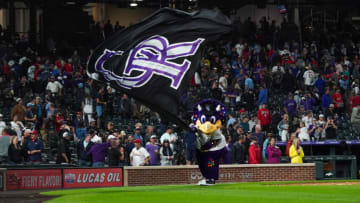 Jul 1, 2021; Denver, Colorado, USA; Colorado Rockies mascot Dinger celebrates a win against the St. Louis Cardinals at Coors Field. Mandatory Credit: Troy Babbitt-USA TODAY Sports