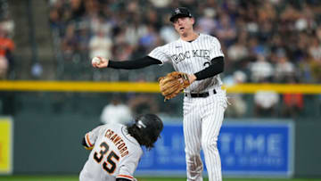 Sep 7, 2021; Denver, Colorado, USA; Colorado Rockies second baseman Ryan McMahon (24) turns a double play over San Francisco Giants shortstop Brandon Crawford (35) in the seventh inning at Coors Field. Mandatory Credit: Ron Chenoy-USA TODAY Sports