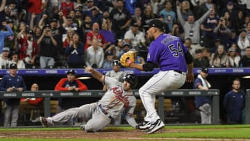 Jun 3, 2022; Denver, Colorado, USA; Atlanta Braves left fielder Adam Duvall (14) slides in at home for a score on a wild pitch by Colorado Rockies relief pitcher Carlos Estevez (54) in 10th inning at Coors Field. Mandatory Credit: John Leyba-USA TODAY Sports