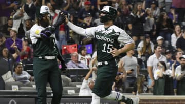 Jun 4, 2022; Denver, Colorado, USA; Colorado Rockies right fielder Randal Grichuk (15) high fives designated hitter Charlie Blackmon (19) after scoring against the Atlanta Braves in the 10th inning at Coors Field. Mandatory Credit: John Leyba-USA TODAY Sports