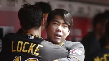 Sep 7, 2015; Cincinnati, OH, USA; Pittsburgh Pirates third baseman Jung Ho Kang (27) hugs starting pitcher Jeff Locke (49) in the dugout at the beginning of a game with the Cincinnati Reds at Great American Ball Park. Mandatory Credit: David Kohl-USA TODAY Sports