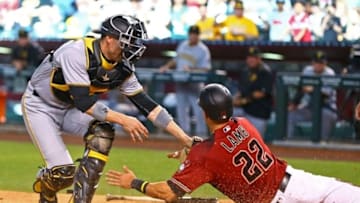 Apr 24, 2016; Phoenix, AZ, USA; Pittsburgh Pirates catcher Chris Stewart (left) tags out Arizona Diamondbacks base runner Jake Lamb in the tenth inning at Chase Field. The Pirates defeated the Diamondbacks 12-10 in 13 innings. Mandatory Credit: Mark J. Rebilas-USA TODAY Sports