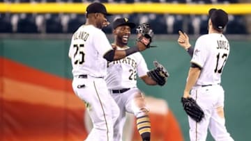May 17, 2016; Pittsburgh, PA, USA; Pittsburgh Pirates left fielder Gregory Polanco (25) and center fielder Andrew McCutchen (22) and right fielder Matt Joyce (17) celebrate after defeating the Atlanta Braves at PNC Park. The Pirates won 12-9. Mandatory Credit: Charles LeClaire-USA TODAY Sports