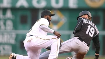 May 20, 2016; Pittsburgh, PA, USA; Pittsburgh Pirates second baseman Josh Harrison (5) tags out Colorado Rockies center fielder Charlie Blackmon (19) on a steal attempt during the third inning at PNC Park. Mandatory Credit: Charles LeClaire-USA TODAY Sports