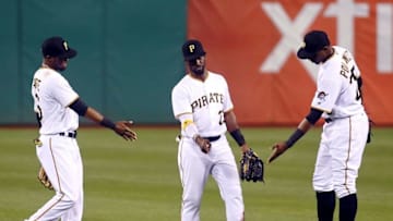 Apr 30, 2016; Pittsburgh, PA, USA; Pittsburgh Pirates left fielder Starling Marte (6) and center fielder Andrew McCutchen (22) and right fielder Gregory Polanco (25) react in the outfield after defeating the Cincinnati Reds at PNC Park. The Pirates won 5-1. Mandatory Credit: Charles LeClaire-USA TODAY Sports