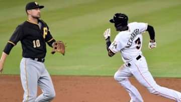 Jun 2, 2016; Miami, FL, USA; Miami Marlins shortstop Adeiny Hechavarria (3) rounds second base past Pittsburgh Pirates shortstop Jordy Mercer (10) after Hechavarria connected for a triple during the second inning at Marlins Park. Mandatory Credit: Steve Mitchell-USA TODAY Sports
