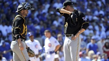 Jun 17, 2016; Chicago, IL, USA; Pittsburgh Pirates catcher Chris Stewart (19) and relief pitcher Cory Luebke (26) react after Chicago Cubs second baseman Ben Zobrist (not pictured) scores in the sixth inning of their game at Wrigley Field. Mandatory Credit: Matt Marton-USA TODAY Sports